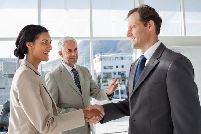 Businessman introducing a colleague to another businessman.jpeg