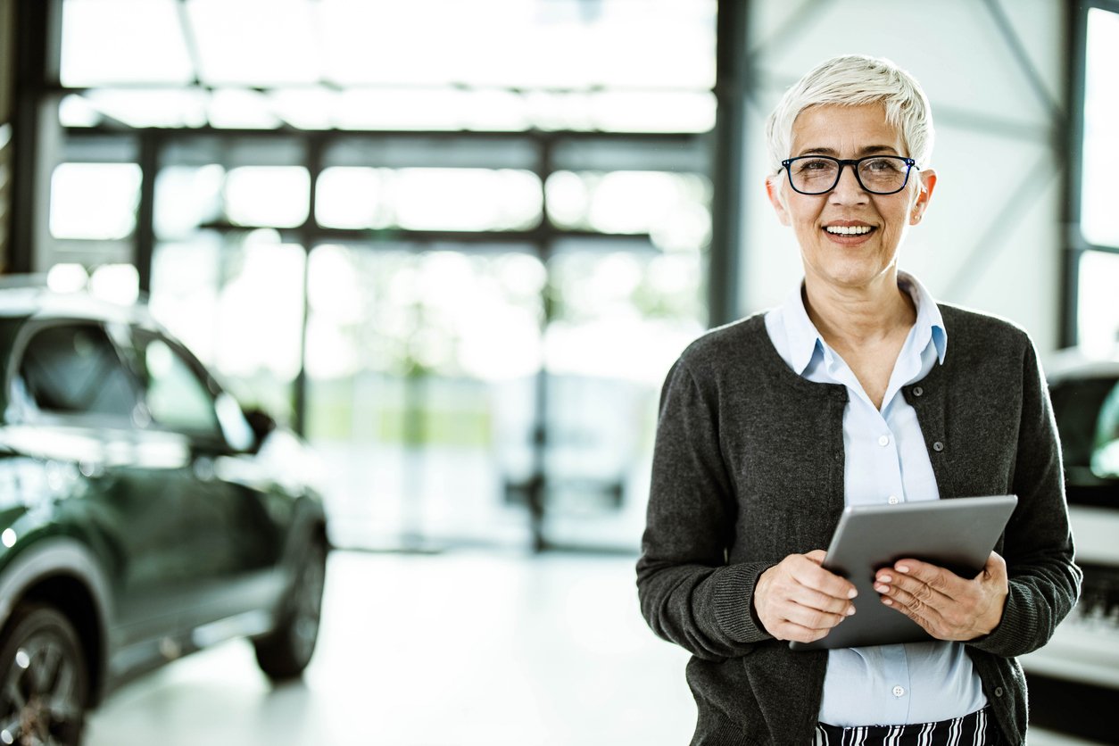 woman smiling at camera automotive dealership